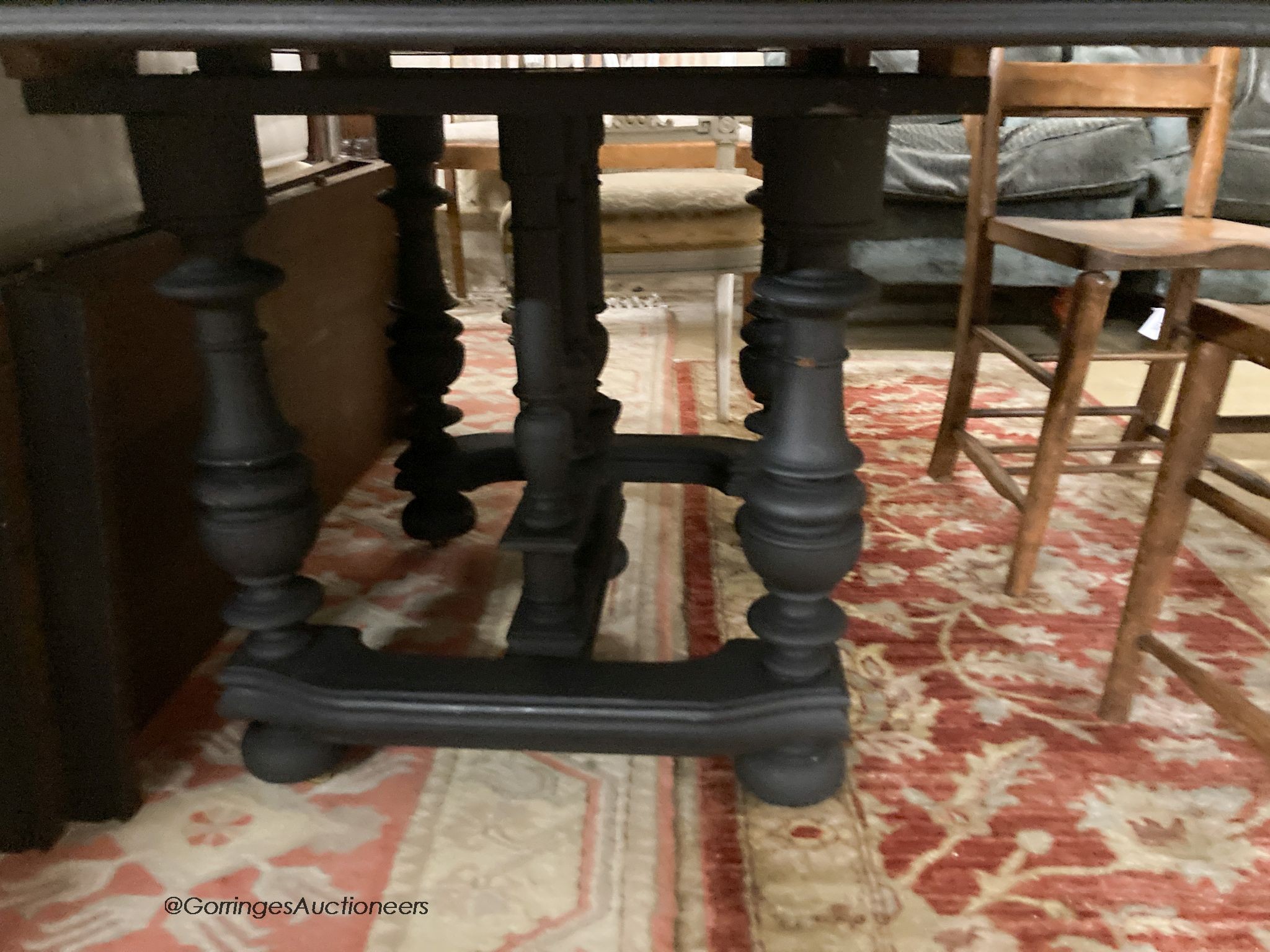 A 19th century French stripped oak and painted extending dining table, 210cm extended, two spare leaves, D.103cm H.71cm